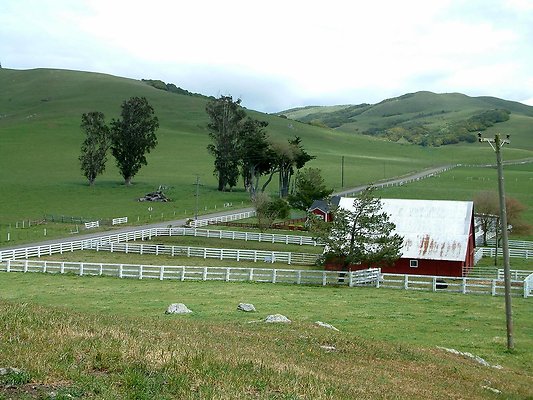 0. Pan from hill behind ranch